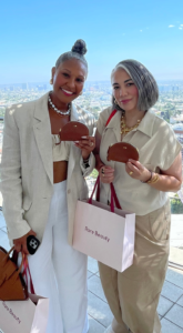 Guests holding their personalized monogrammed powder pouches onsite at the Rare Beauty product launch event by Selena Gomez, held at 1 Hotel West Hollywood.