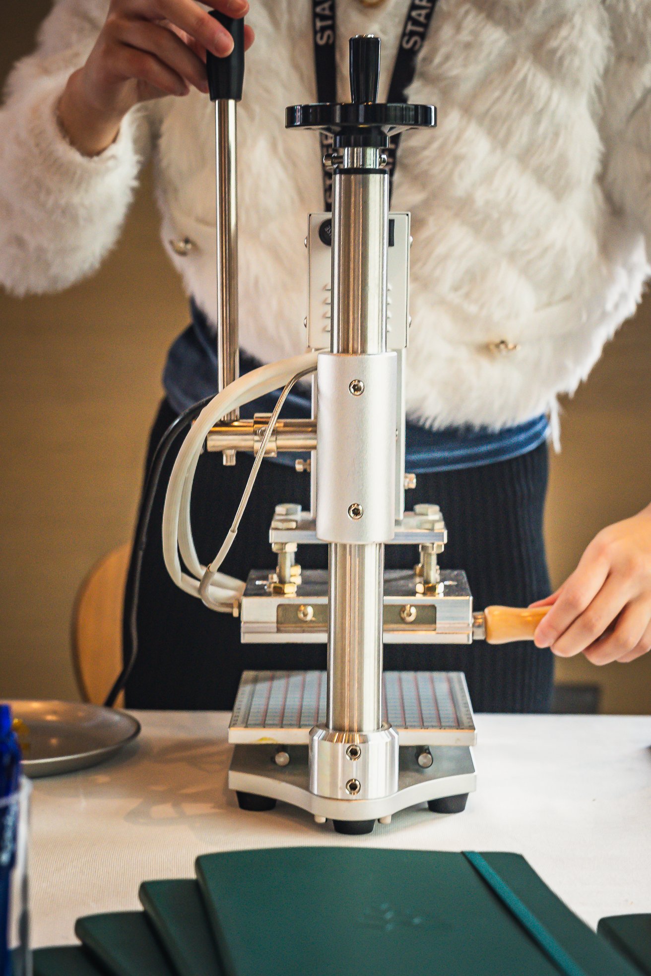 Guest holding personalized onsite embossed leather laptop case at Snapchat Leadership Summit, showcasing unique event activation with monogram and custom embossing.