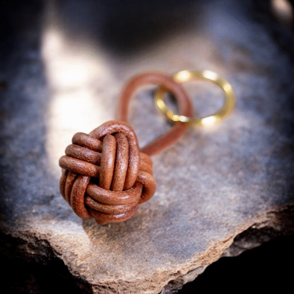 Brown leather monkey fist keychain with solid brass keyring, handcrafted for durability and style.