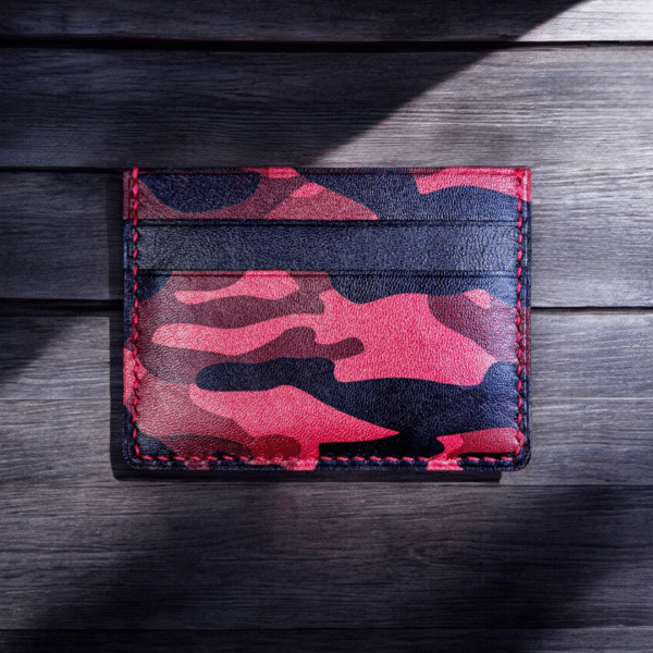 Handcrafted full grain goat leather doubled-sided cardholder with two card slots on each side and a middle slot for folded cash and cards, featuring a bold red camouflage pattern.