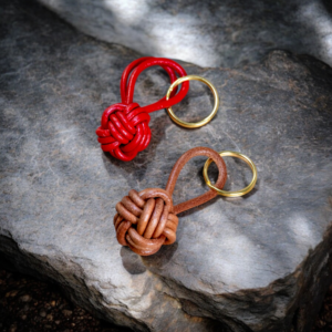 Red and brown leather monkey fist keychain with solid brass keyring, hand-tied with top-grain cow leather.