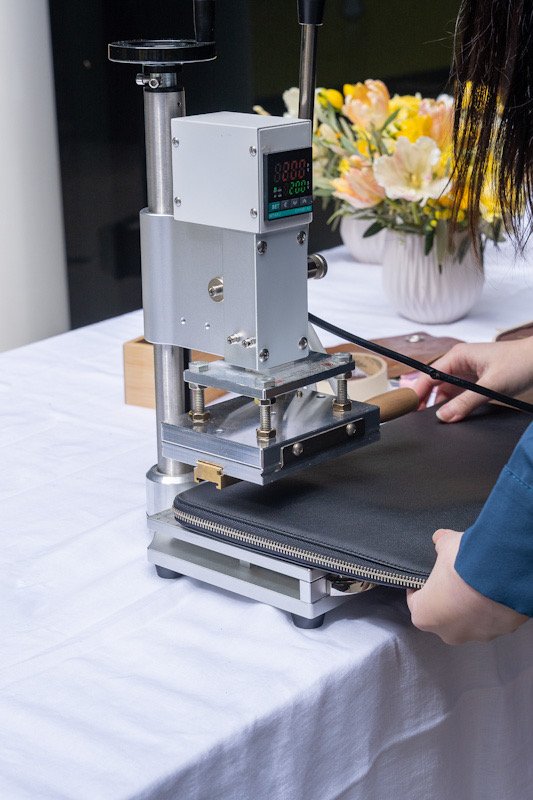 Snapchat_Leadership_Summit_2025_Onsite_Debossing_Process_Luxury_Leather Onsite debossing process in action at the Snapchat Leadership Summit, with a leather item being personalized using a high-quality debossing machine.