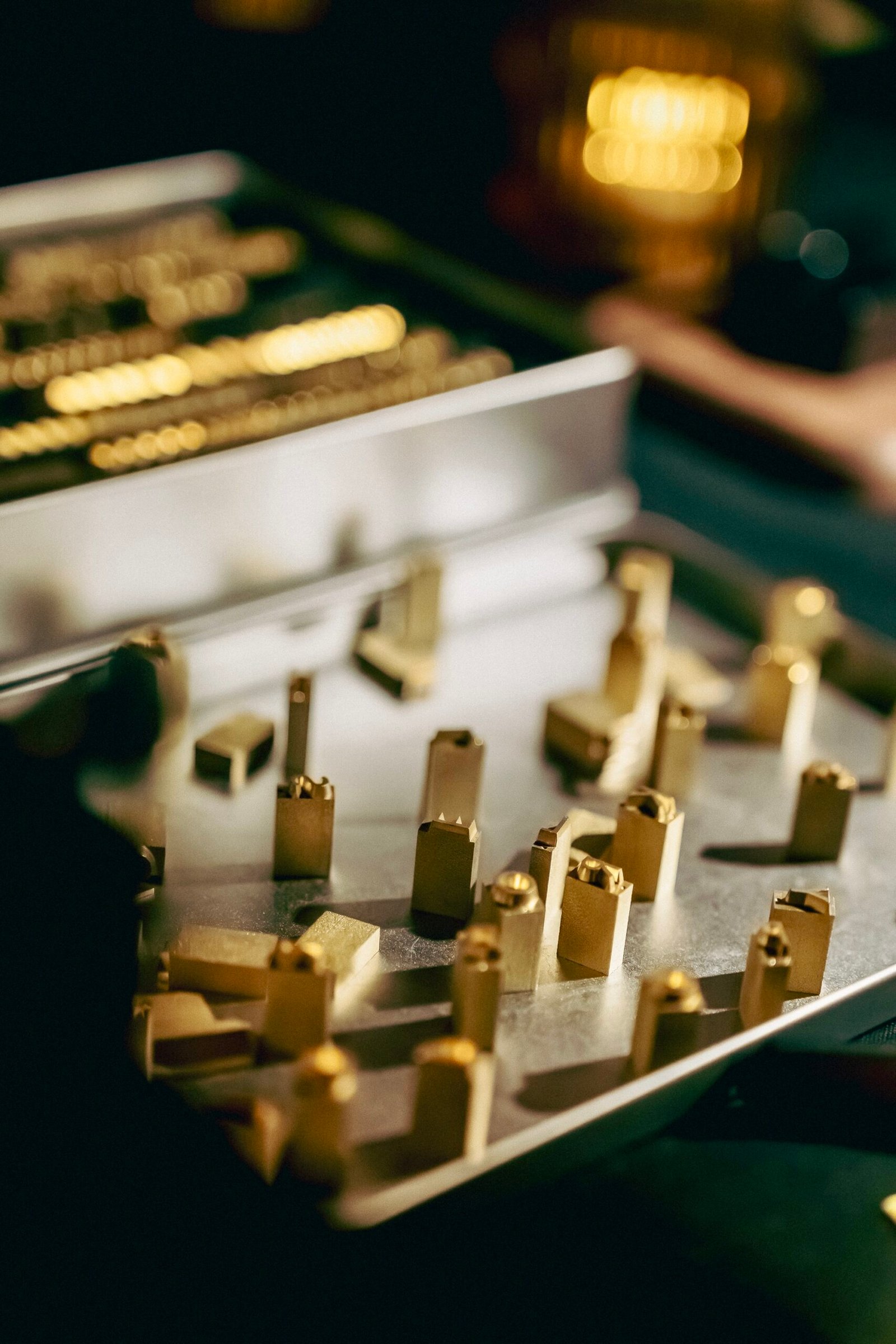 Brass alphabet embossing set used for personalizing leather goods at onsite activations and events.