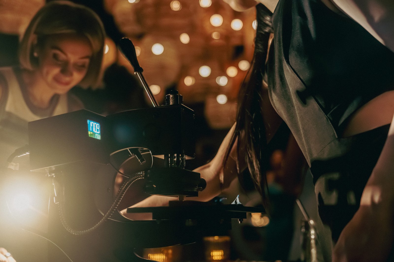 Guest smiling while picking up her personalized leather wristband at Rare Beauty’s 5th anniversary celebration.