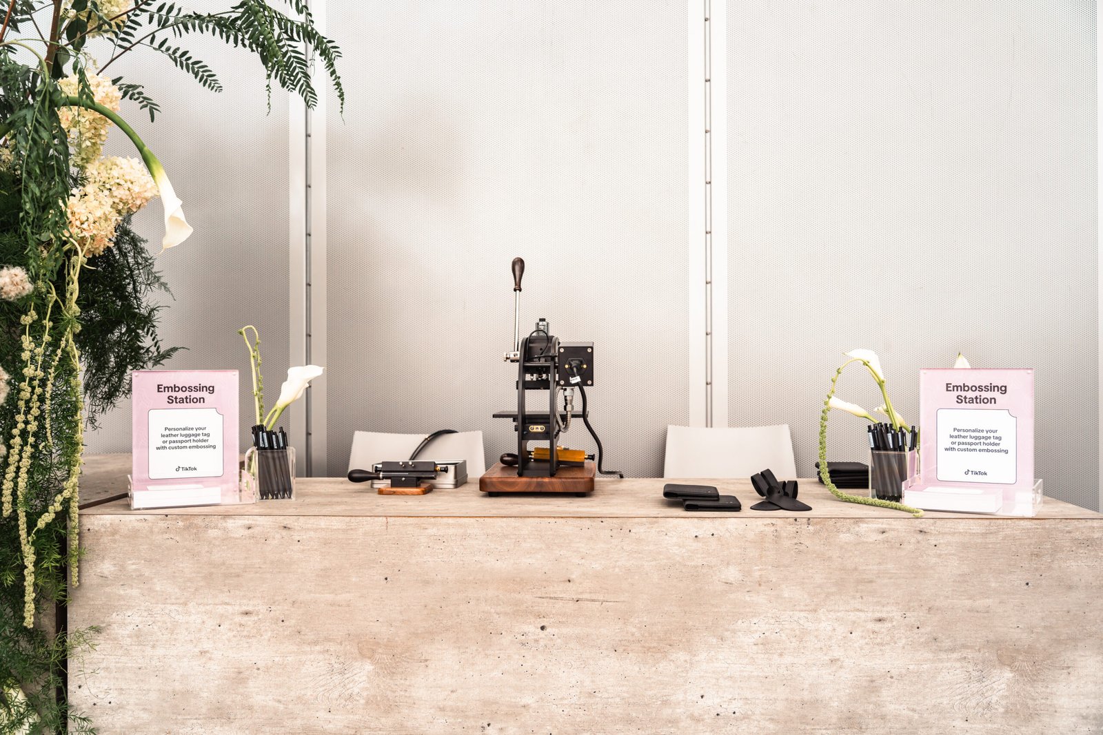 Onsite embossing setup at Napa Stanly Ranch for a tech financial conference, showcasing monogrammed leather cover notebooks for guests.