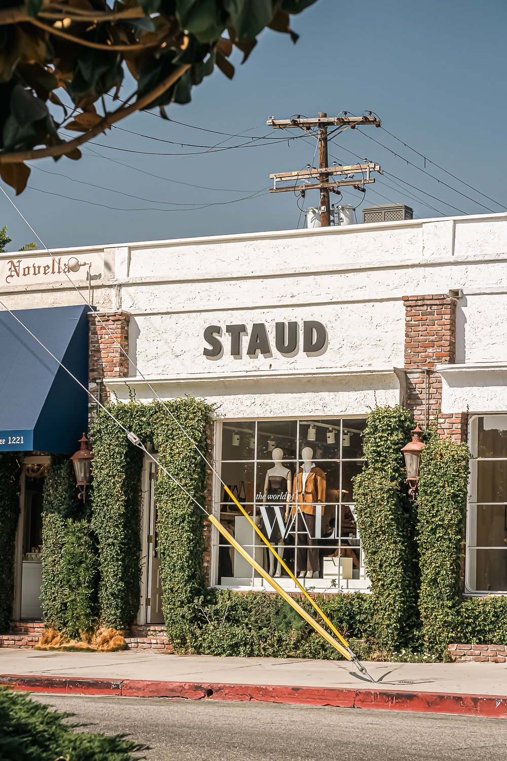 Personalized Wally Boots at Staud Melrose Personalized leather wristband with embossed initials KF, worn at Rare Beauty 5th anniversary while guests dance and celebrate in the background.