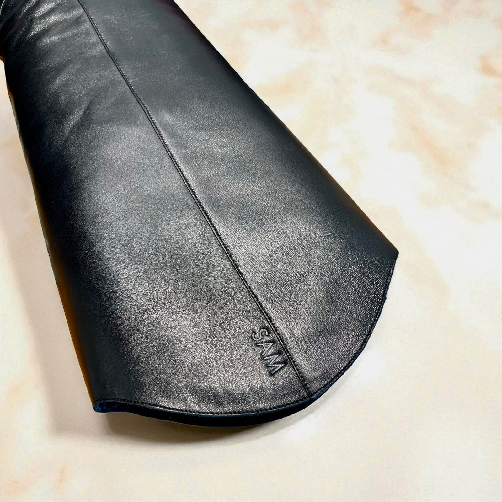 Personalized Wally Boots at Staud Melrose Brass alphabet embossing set used for personalizing leather goods at onsite activations and events.