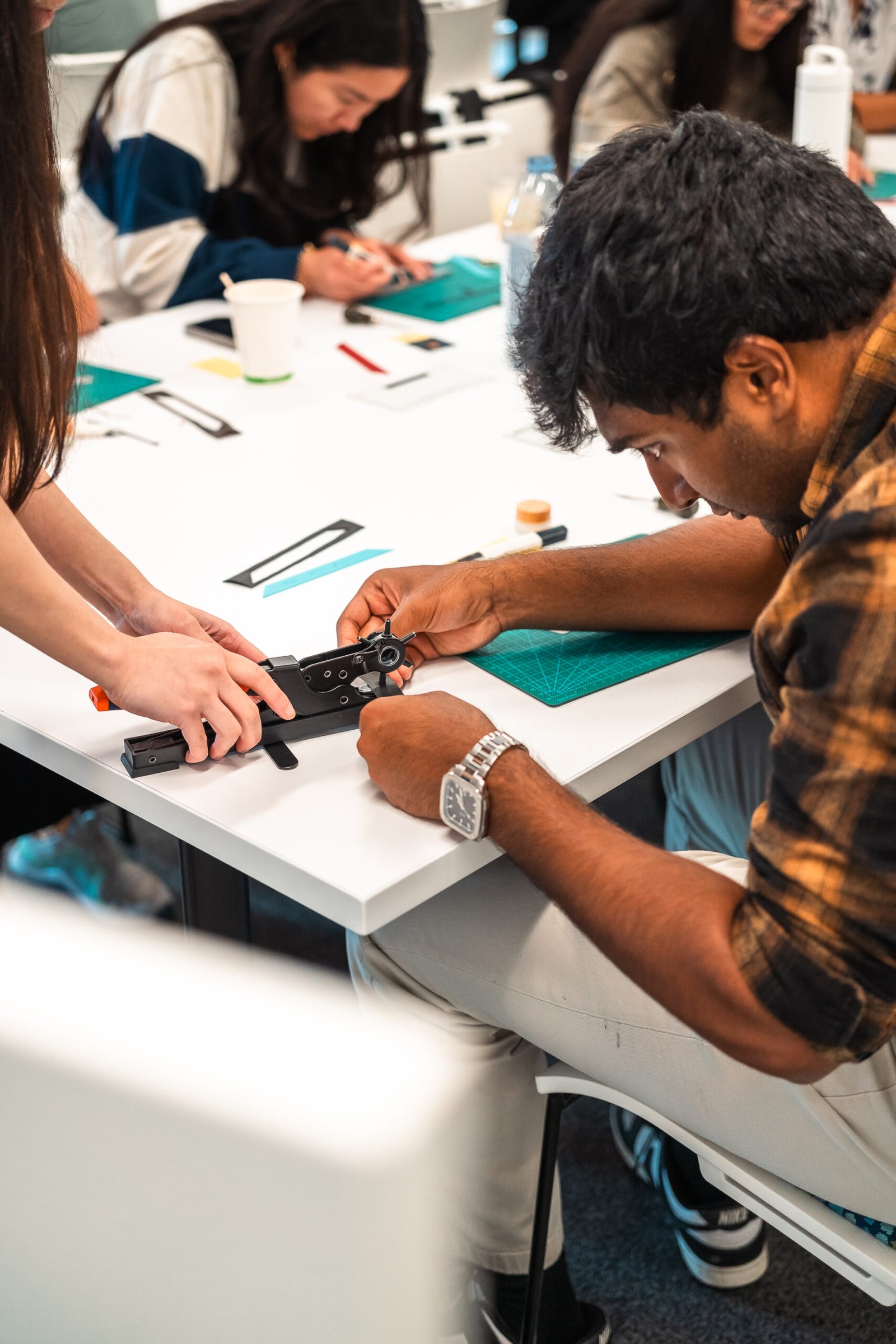 Black vegan leather license plate keychain with gold foil embossed initials SAK, created at Prime Video’s Maintenance Required premiere.