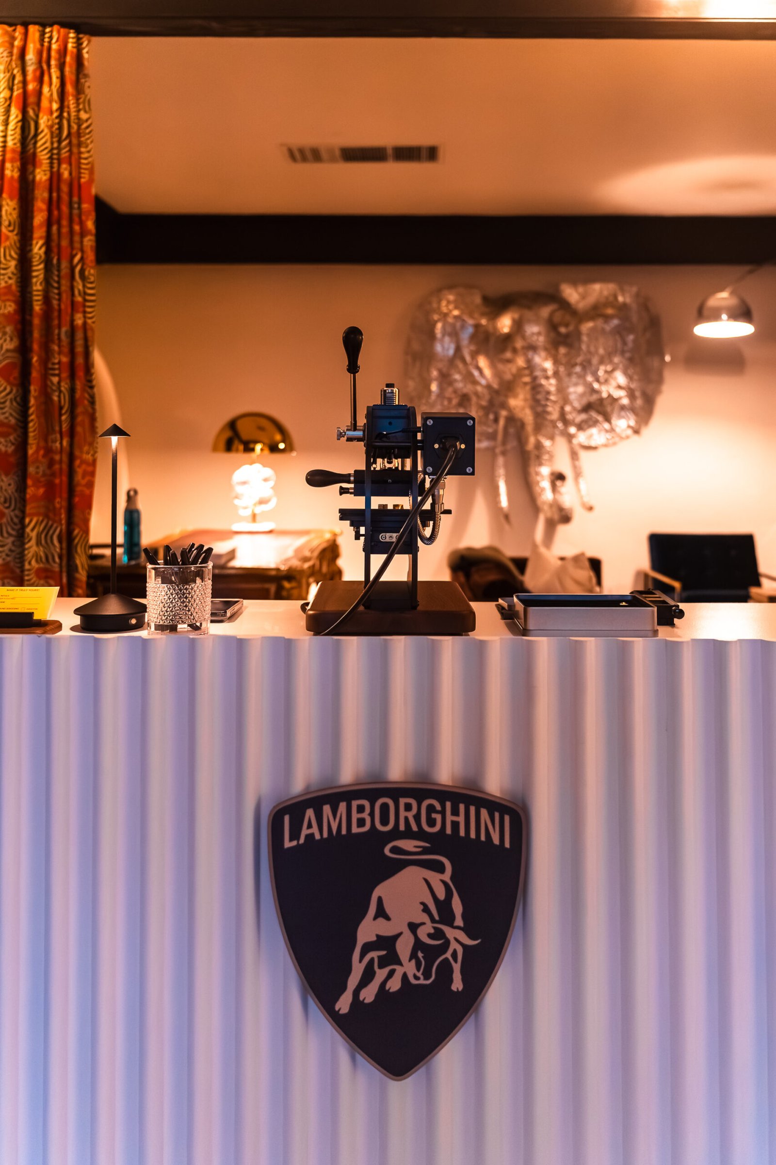 Lambo_Embossing_Station Two influencers capturing photos and videos of the onsite embossing station at Prime Video’s Maintenance Required premiere.