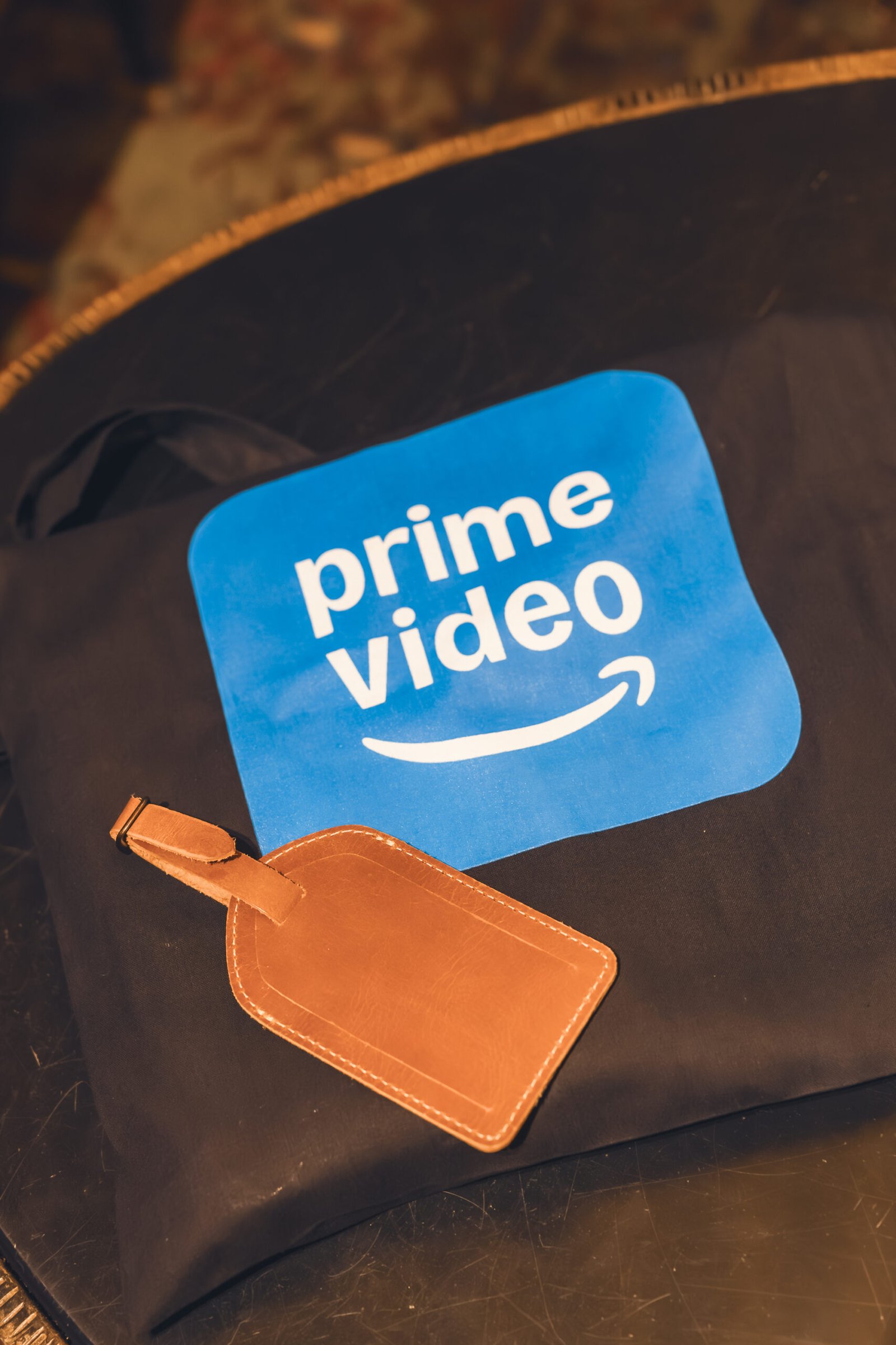 Prime Video Luggage Tag Maintenance Required movie poster displayed at a retro-style premiere venue for Prime Video’s film event.