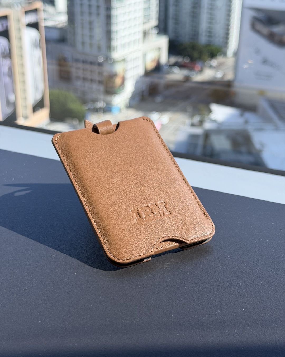 IBM Luggage Tag for Grammy Walmart National Fashion Tour personalization station – western belts embossed with initials and rivet decorations under “Now Delivering Your Rodeo Dream” backdrop