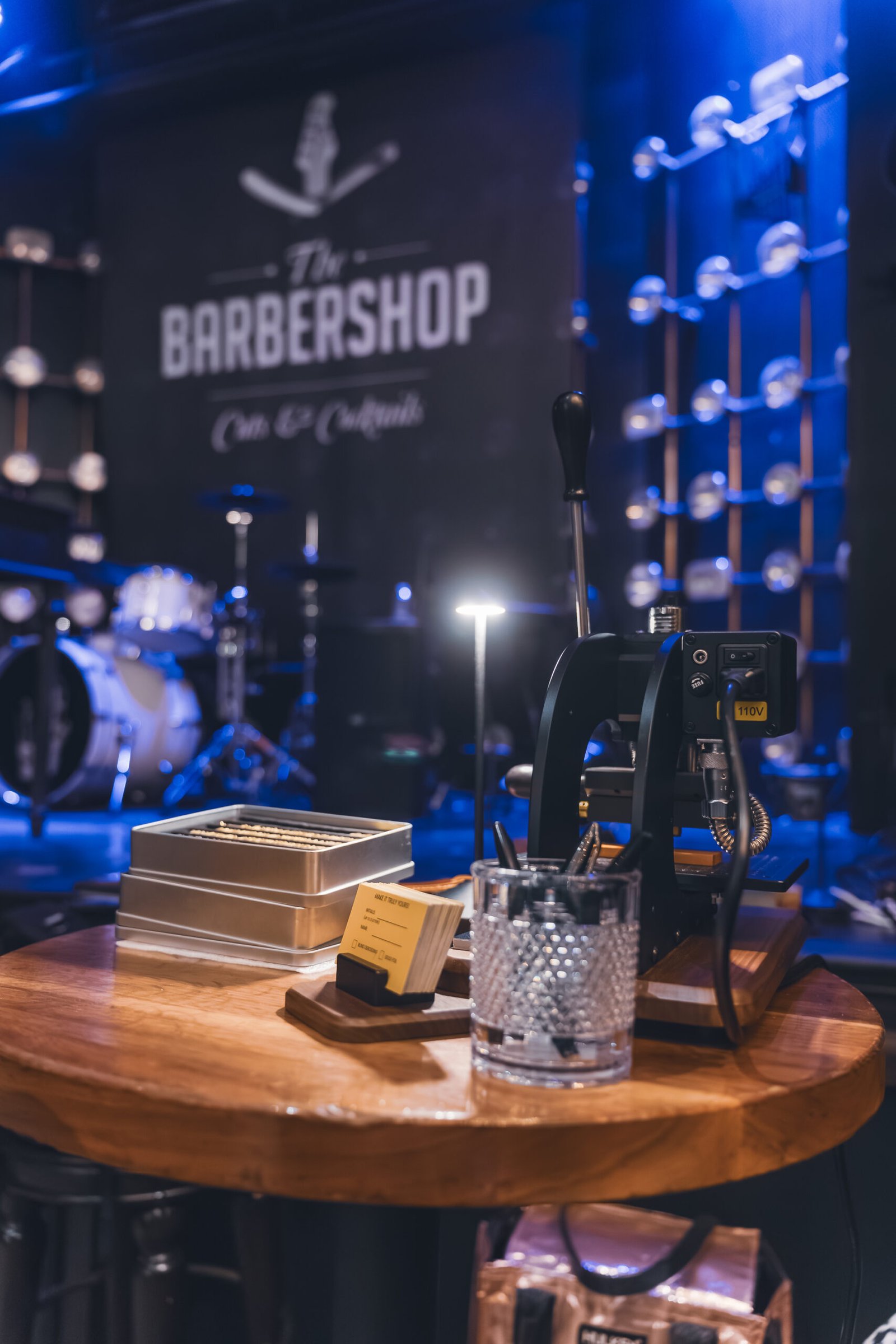 Small Setup Two influencers capturing photos and videos of the onsite embossing station at Prime Video’s Maintenance Required premiere.